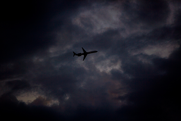 Flying Home For Thanks Giving in a Stormy Sky : Airplane in sky From the Roof of the Insight Building : NYC