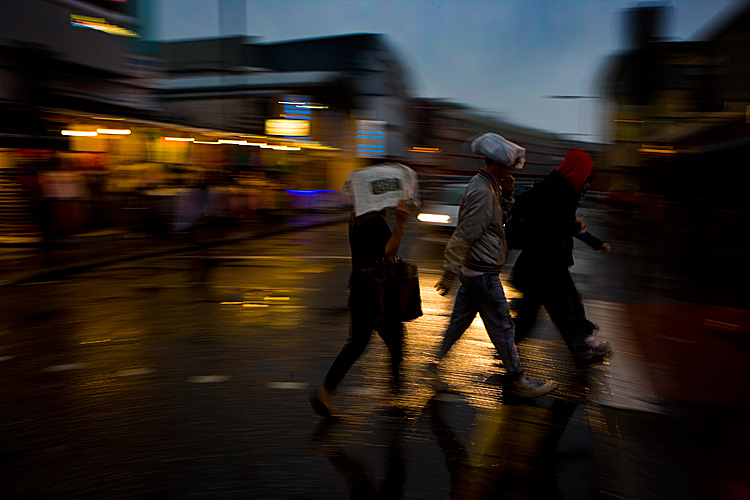 Shoppers Brave Rain and Storms : Camden Lock London : England UK